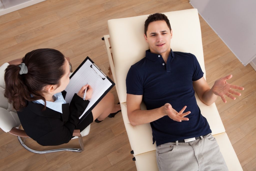 Man lying down while talking to his therapist